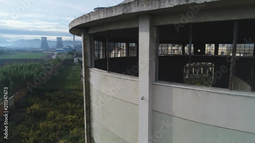 Slow aerial drone flight revealing deteriorated power plant and Communist era industrial zone in Albania, Europe