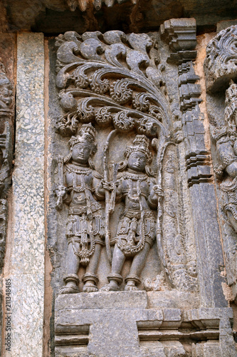 Ornate wall panel reliefs depicting Kamdev and his wife Rati, Kedareshwara temple, Halebidu, Karnataka