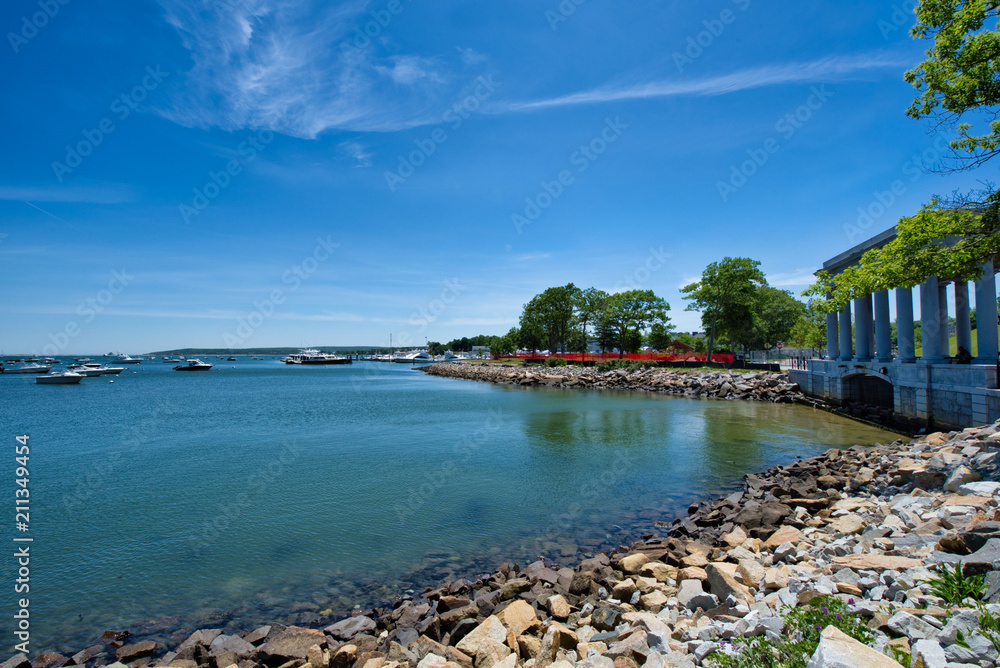 The shoreline of an Easterly state on a sunny, summer day in Cape Cod