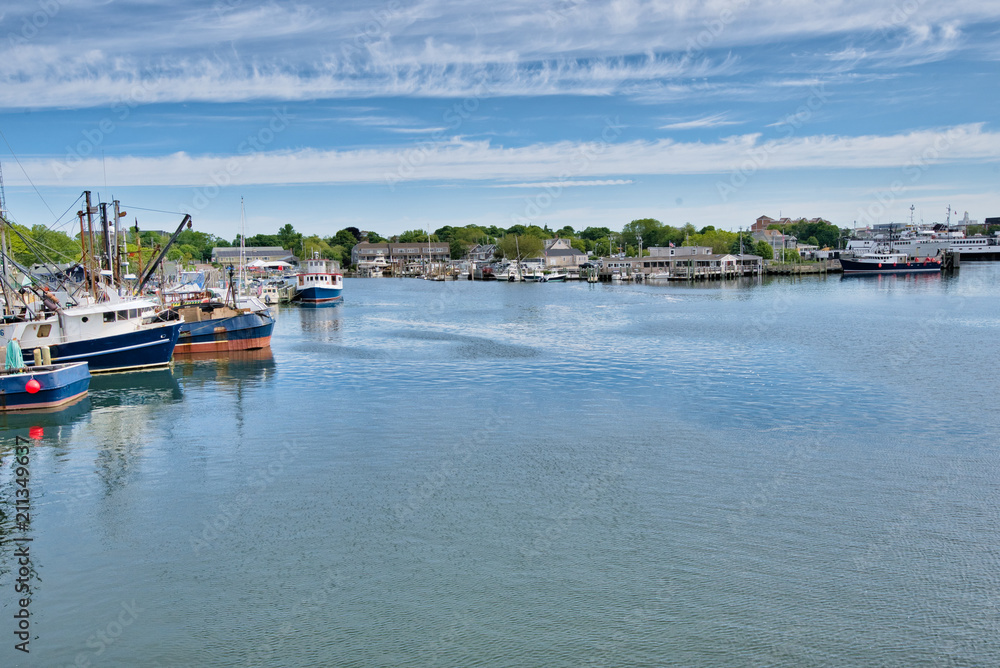 boats sit quietly in a harbor in Cape Cod