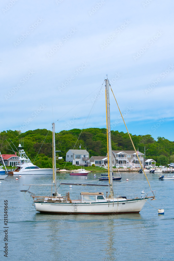 A sailboat is moored in the harbor in Hyannis on a summer day