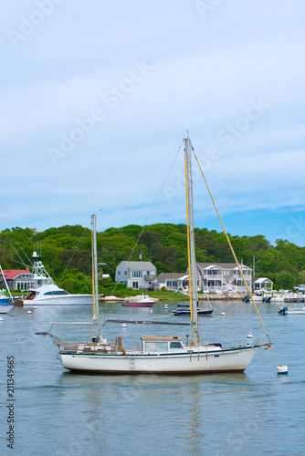 A sailboat is moored in the harbor in Hyannis on a summer day