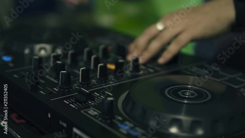 DJ tweak track controls on DJ control panel.
