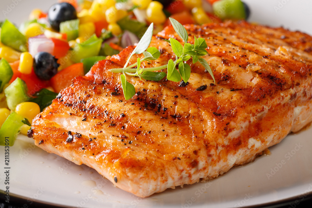 Grilled salmon fillet with salsa of corn, blueberries and pepper macro. horizontal Grilled salmon fillet with salsa of corn, blueberries and pepper macro. horizontal