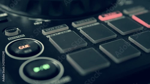 DJ tweak track controls on DJ control panel.