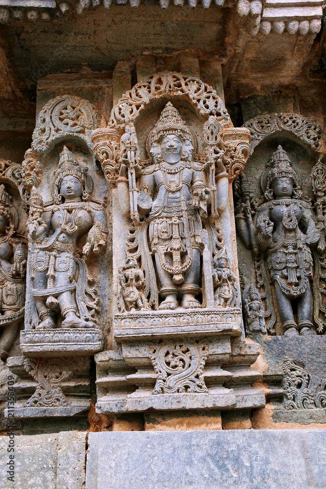Ornate wall panel reliefs depicting lord Brahma in the centre and other deities, North wall, Kedareshwara temple, Halebidu, Karnataka