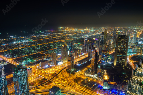 Night view of Dubai skyscrapers at financial district from Burj Khalifa. Dubai, United Arab Emirates