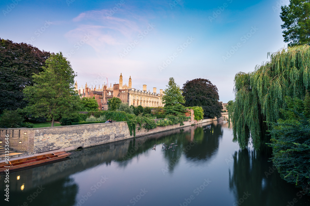 View of Cam river and the ornamented facade of Clare College at sunrise in Cambridge, UK