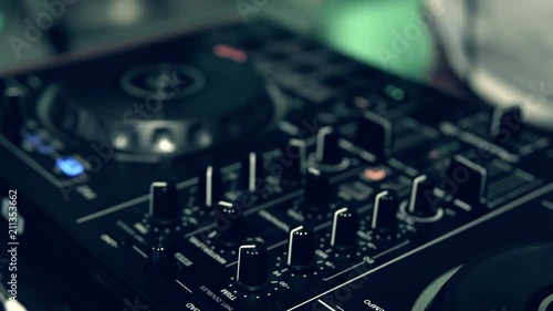 DJ tweak track controls on DJ control panel.
