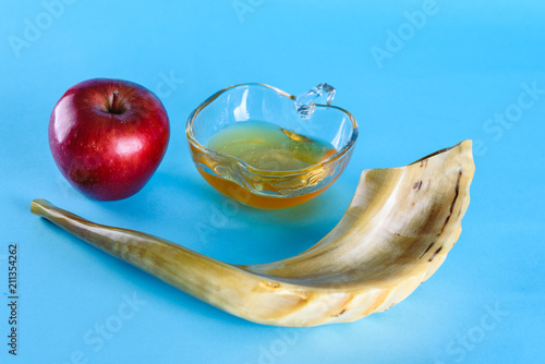 Rosh Ha Shana - Jewish new year composition of an red apple,  jar of honey and Shofar horn for Rosh Hashanah.