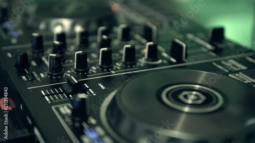 DJ tweak track controls on DJ control panel.