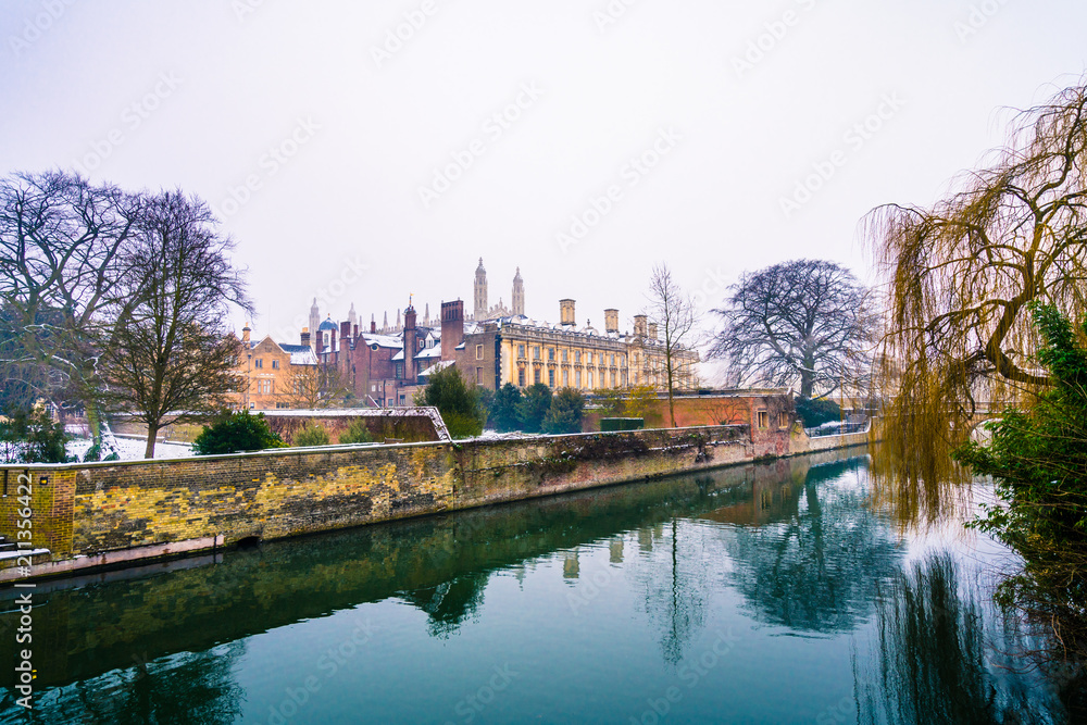 View of Cam river and the ornamented facade of Clare College at sunrise in Cambridge, UK