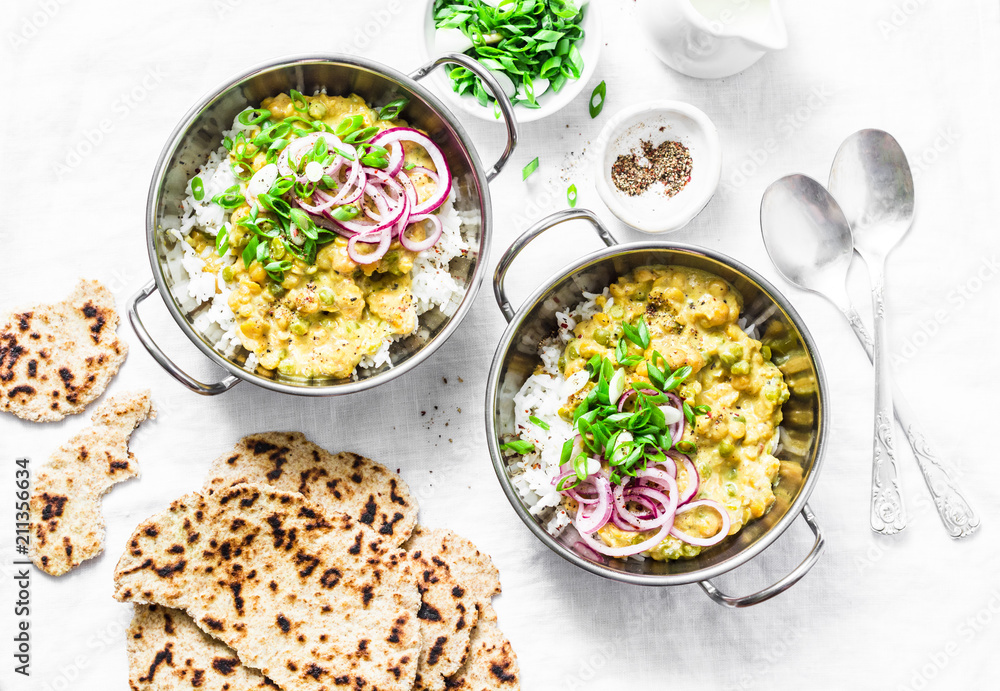 Indian dhal with jasmine rice, marinated red onion, scallion and whole grain flatbread on light background, top view. Flat lay, vegetarian food concept Indian dhal with jasmine rice, marinated red onion, scallion and whole grain flatbread on light background, top view. Flat lay, vegetarian food concept