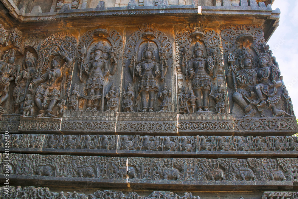 Ornate wall panel reliefs depicting, from left, a Goddess, Lord Brahma, Mahesh, Shiva, lord Vishnu and Shiva-Parvati, Hoysaleshwara temple, Halebidu, Karnataka