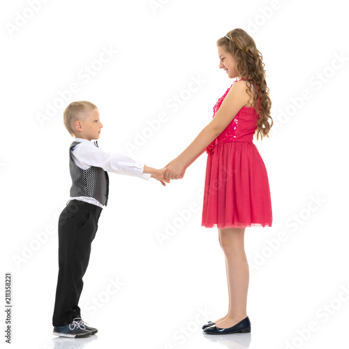 A boy and a girl are holding hands.