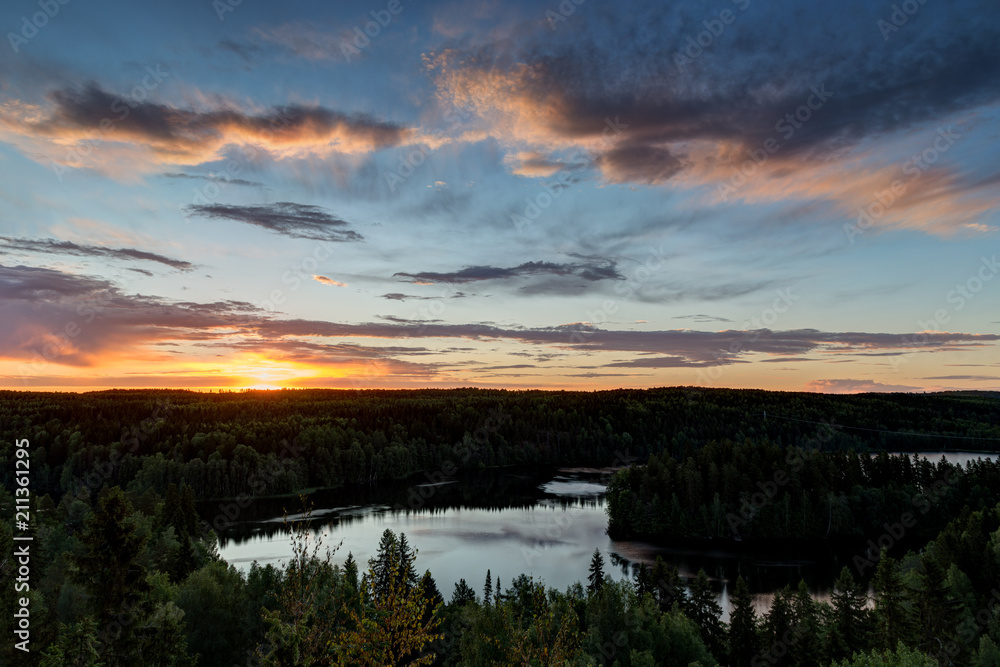 Scenic and beautiful view of a lake, forest and sky from the Aulanko lookout tower in Hämeenlinna, Finland, in the summer at sunrise. Copy space.