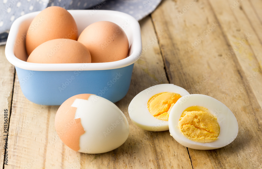 Hard boiled chicken eggs on rustic wooden table Hard boiled chicken eggs on rustic wooden table
