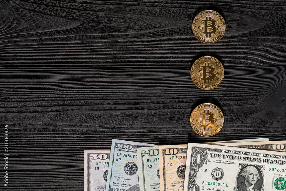 golden bitcoin coin on us dollars close up. Electronic crypto currency golden bitcoin coin on us dollars close up. Electronic crypto currency