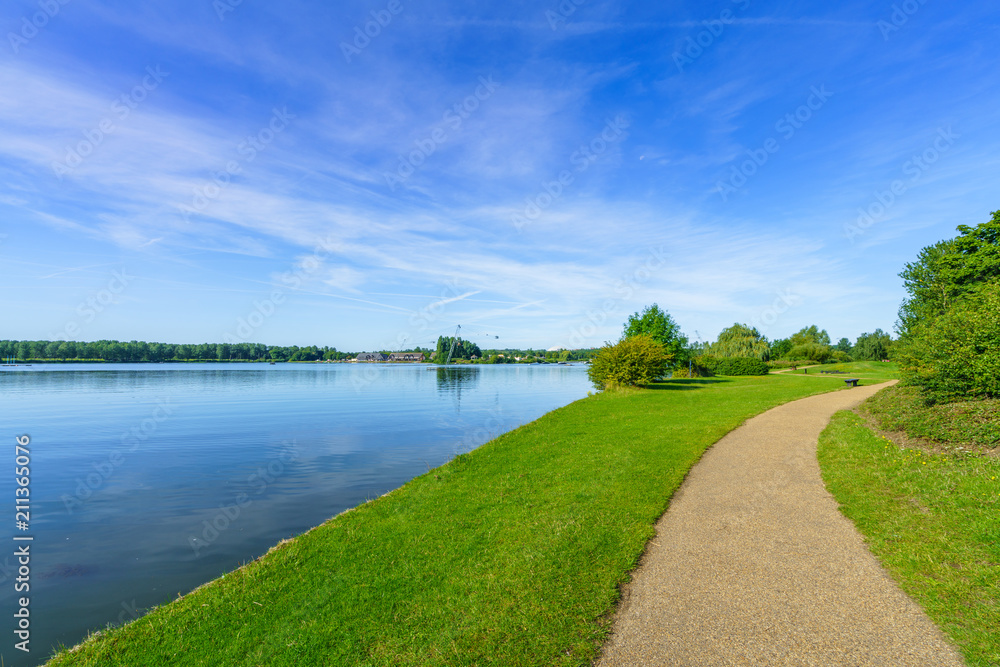 Willen Lake with pedestrian path at sunny summer day Willen Lake with pedestrian path at sunny summer day