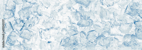 Ice cubes blue wide background.