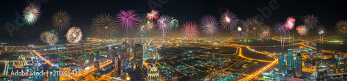 Aerial panorama of Dubai city at night with firework display