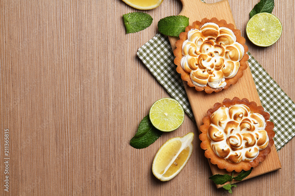 Lemon tart on the board. Lemons and lime