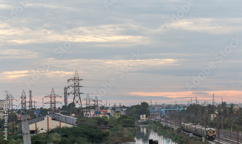 Electricity power substation in chennai india  where electrical power is generated  transmitted  and distributed to systems. Photographed during sunset with low lighting conditions  dark clouds in sky
