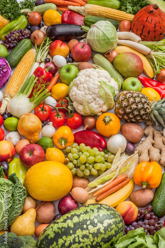 Vegetables and fruits large fresh overhead mix raw food vegetarian arrangement colorful background in studio