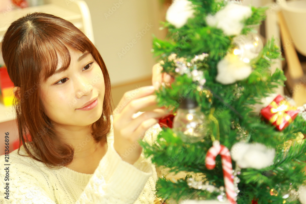 クリスマスツリーの準備をする女性