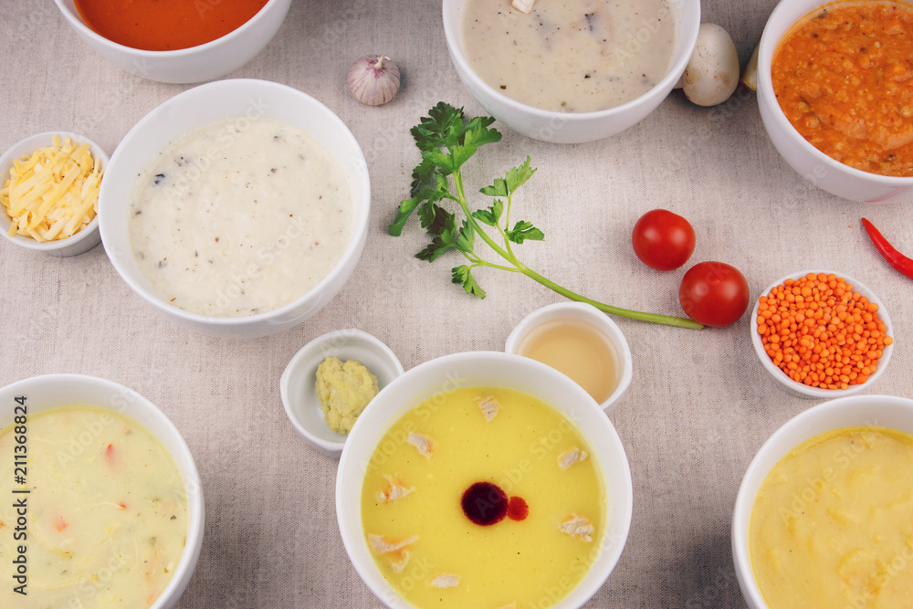 Many plates with different soups on the table Many plates with different soups on the table