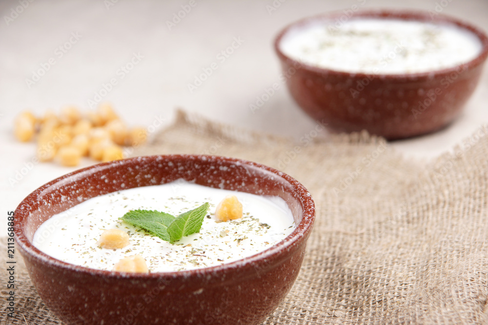 Plates of Turkish soup with chickpeas and mint on the table, decor in a rustic style Plates of Turkish soup with chickpeas and mint on the table, decor in a rustic style