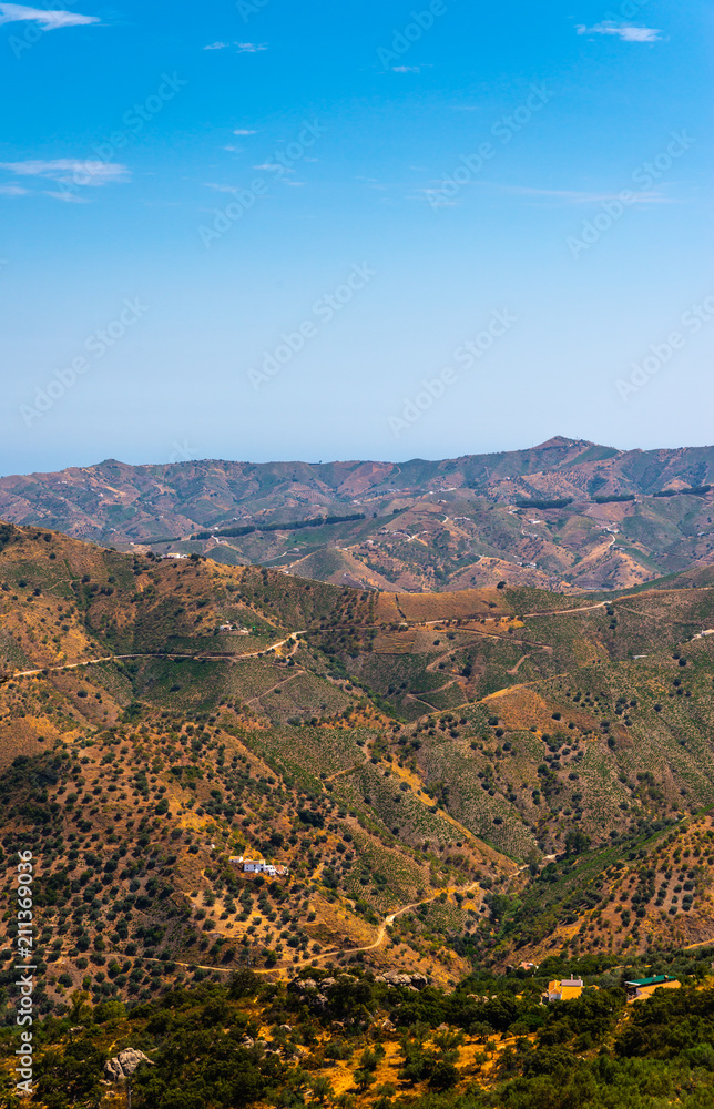 Fototapeta premium beautiful view of the mountains in the region of Andalusia, houses and farmland on the slopes of mountains