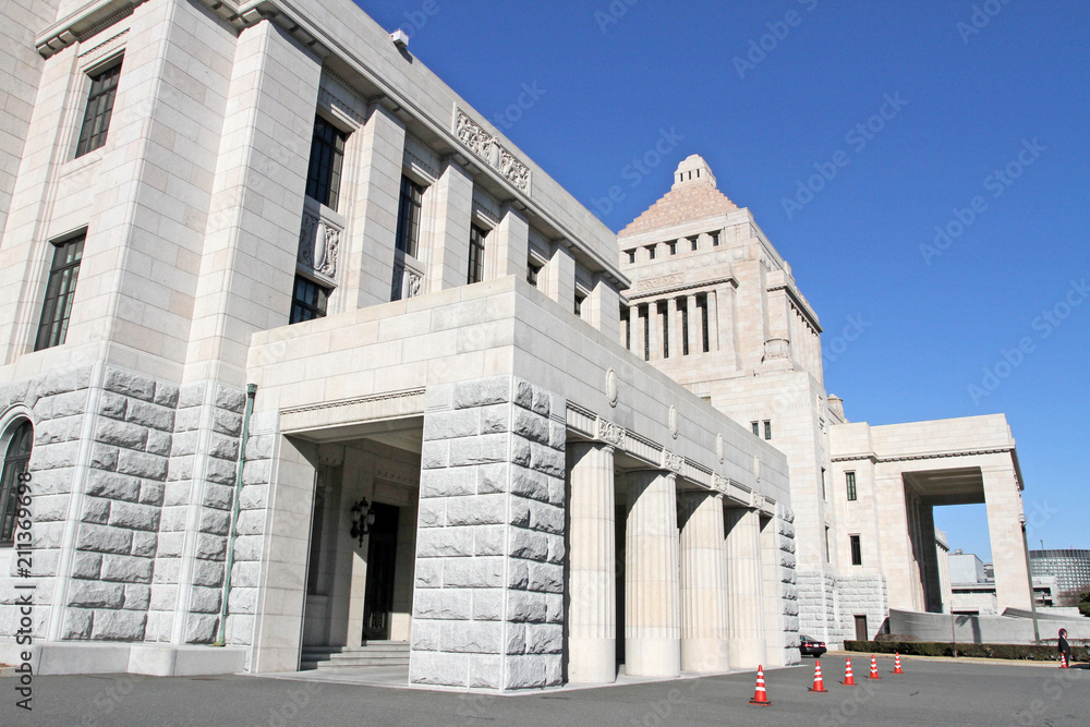 The unique, classic granite central tower of the National Diet Building of Japan, the meeting place of the national government, rises into a blue sky in Tokyo. National diet building -Kokkaigijido The unique, classic granite central tower of the National Diet Building of Japan, the meeting place of the national government, rises into a blue sky in Tokyo. National diet building -Kokkaigijido