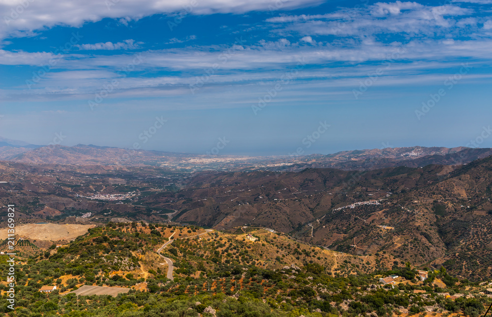 Obraz premium beautiful view of the mountains in the region of Andalusia, houses and farmland on the slopes of mountains