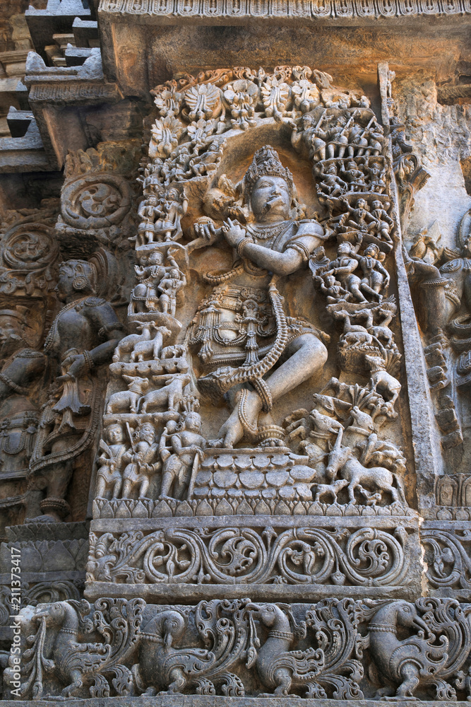 Sculpture of lord Krishna as Muralidhar playing flute , west side wall, Hoysaleshwara temple, Halebidu, Karnataka.