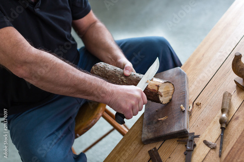 man making three tealight candle holders from rustic wood