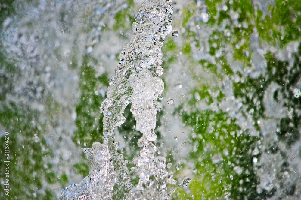 Flying water in motion on a green background Flying water in motion on a green background