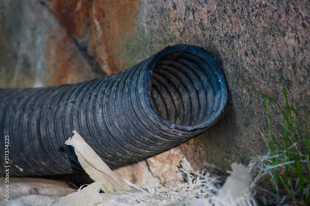 Fototapeta premium Black used corrugated plastic hose is close