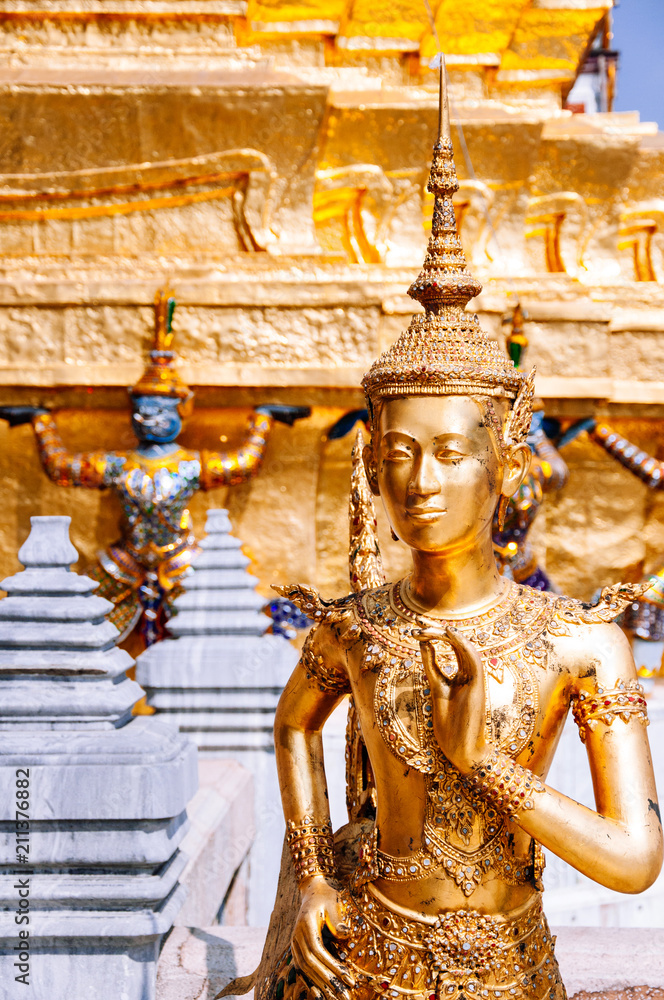 Fototapeta premium Golden angel statue at Emerald Buddha temple or Wat Phra Keaw, Bangkok grand palace