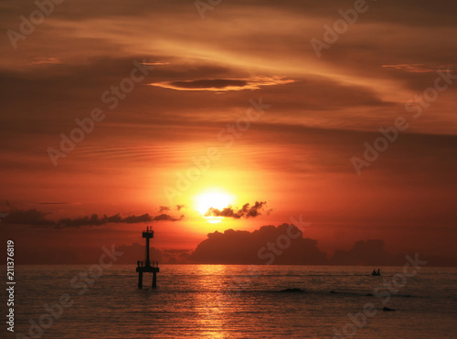 lighthouse on sunset time in the ocean silhouette