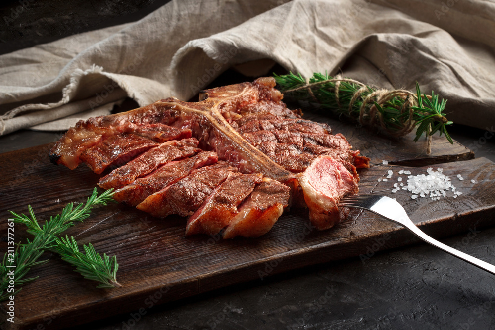 porterhouse steak grilled sliced on a piece of wood Board porterhouse steak grilled sliced on a piece of wood Board
