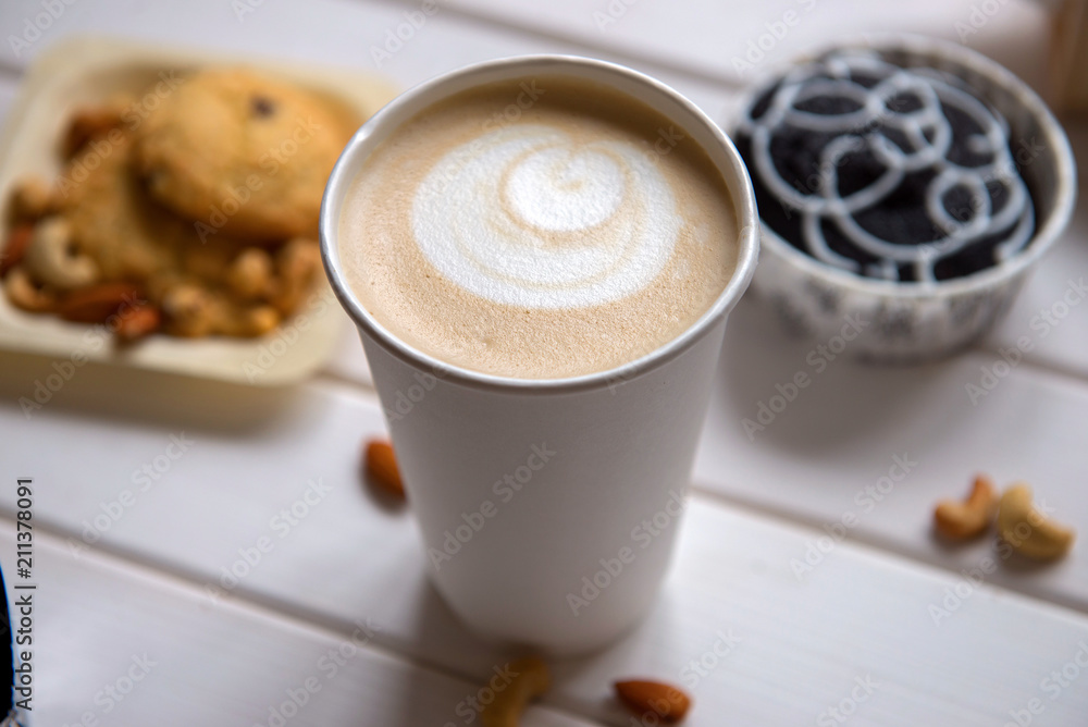 Cup of coffee on wood background with snacks Cup of coffee on wood background with snacks