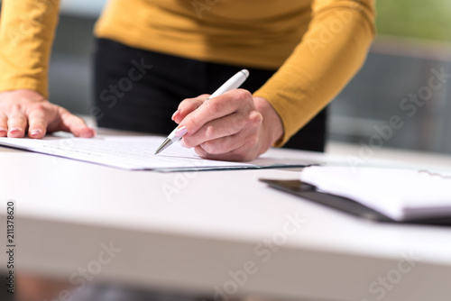 Businesswoman signing document photo