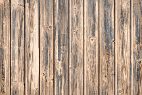Brown wooden boards of oak color. Vintage old fence or wall of house. Fittings of screws. Background abstract pattern.
