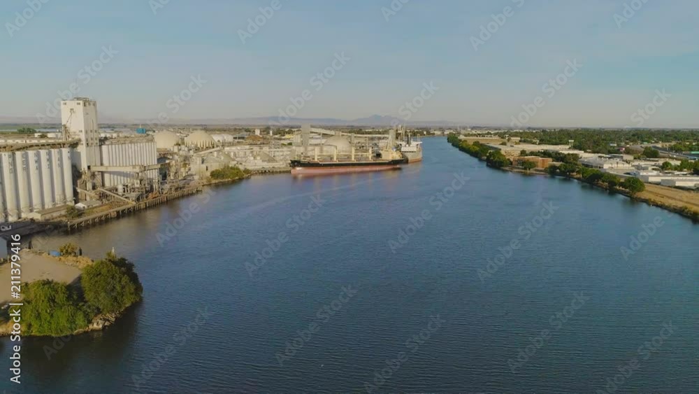San Joaquin River from Lathrop to Stockton. There are several bridges along with the Port of Stockton. Loaded ships can be seen in the port on the water. San Joaquin River from Lathrop to Stockton. There are several bridges along with the Port of Stockton. Loaded ships can be seen in the port on the water.