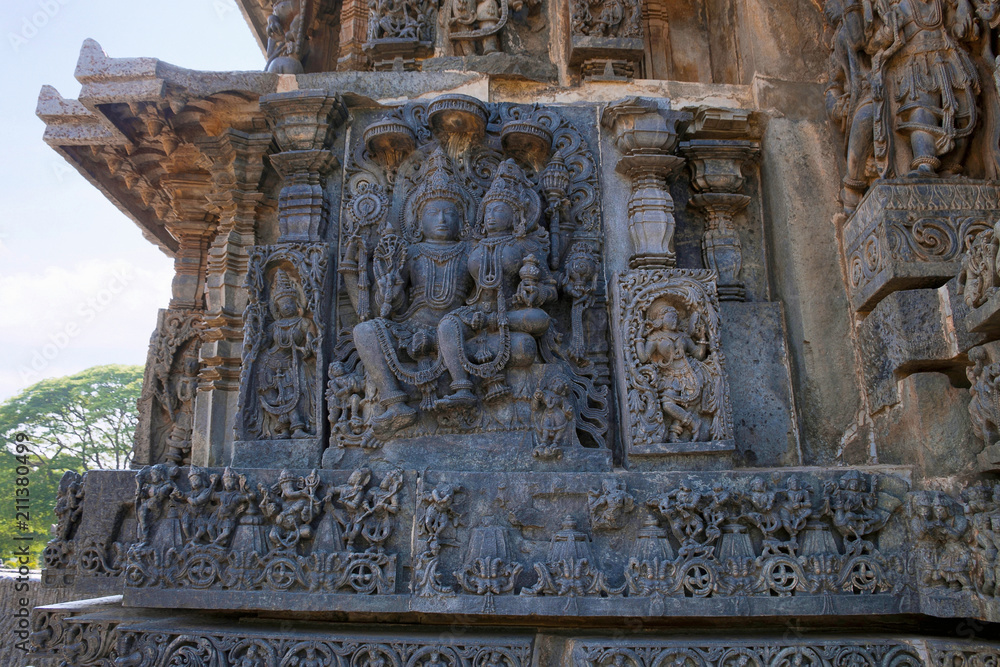 Sculptures on the facade, west side walls. Shiva-Parvati. Hoysaleshwara temple, Halebidu, Karnataka. view from West.