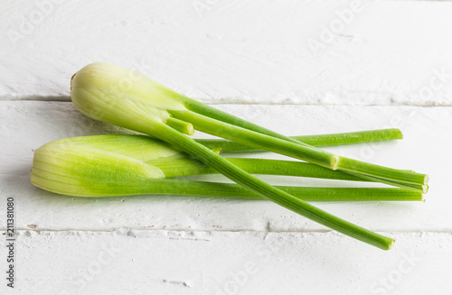 Fresh fennel isolated on white rustic wooden table