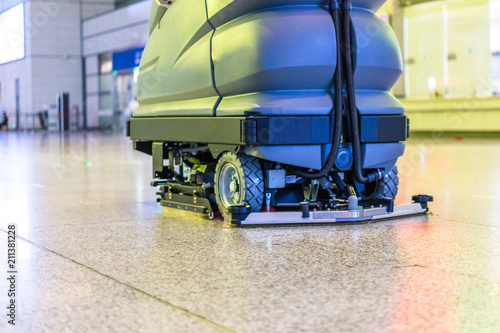 Photos cleaning floor with machine