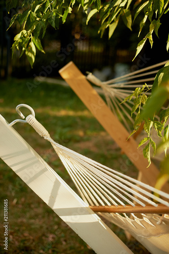 Element, detail, light hammock made of natural materials. Ropes, white cotton and wood. Rest in the garden, in the country