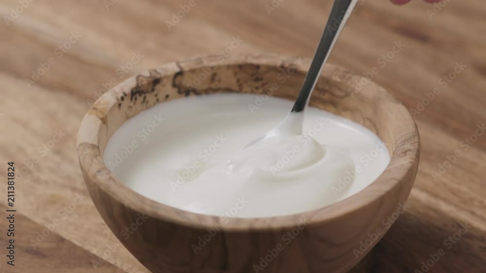 Slow motion of taking sour cream with spoon Slow motion of taking sour cream with spoon